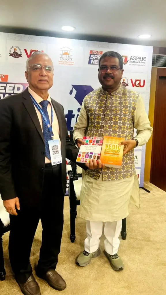 Prof. (Dr.) R. P. Banerjee presenting his books “Vedic Economy” and “Stress Management through Mind Engineering” to Sri. Dharmendra Pradhan, Minister of Education, Govt. of India during the India TV Speed News Education Conclave, 2025 at New Delhi